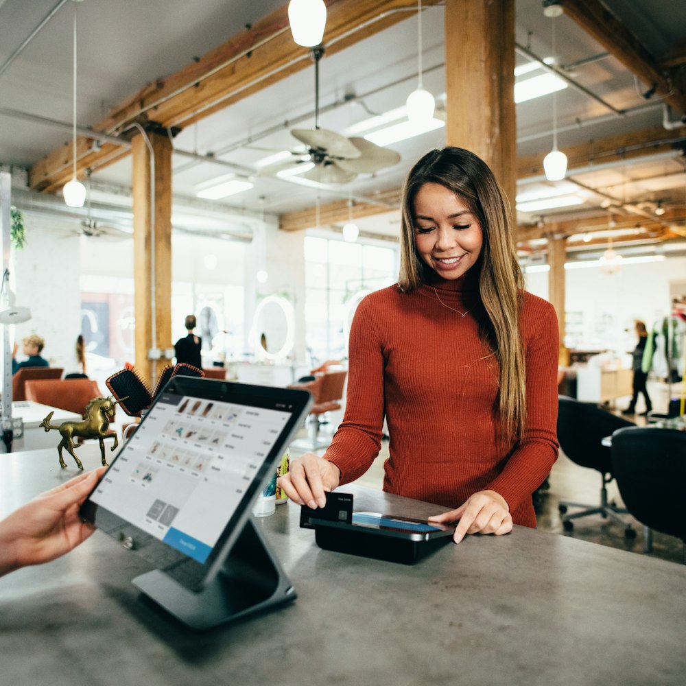 A shop owner helping a customer at the counter
